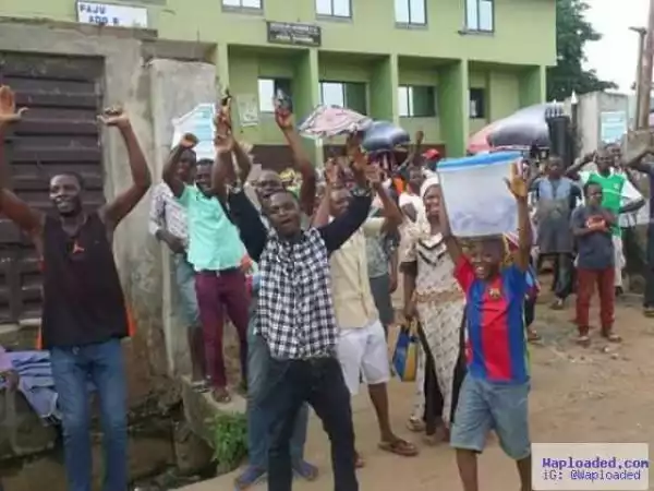 Photos: Ekiti state residents cheer Fayose as he walks on the street